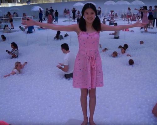 The installation creates a giant indoor beach-like experience, complete with deckchairs, inflatables and an 'ocean' you can swim in / Tiffany Wong