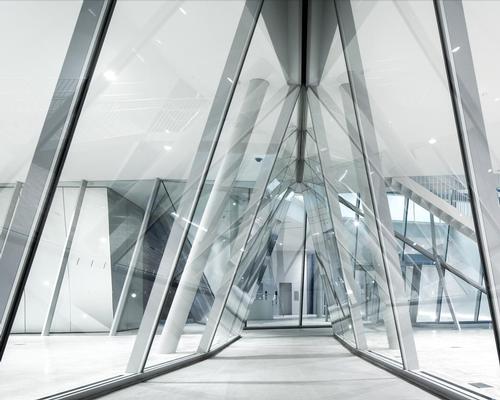 The splits in the facade, which include sloping glass windows, allow people on the outside of the museum to look in, while offering those inside views of the Tokyo skyline / Sumida Hokusai Museum