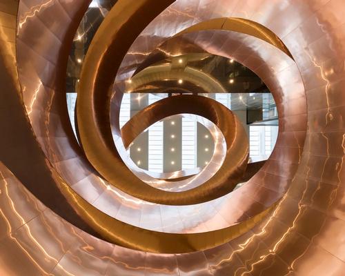 The stairway spirals up through the building and leads visitors to four floors / Adam Mørk