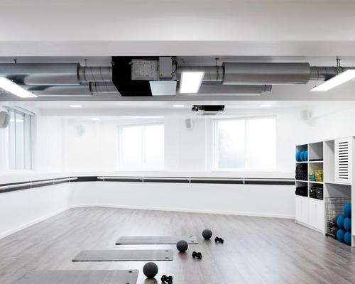 In order to create an expansive feel and add a sense of light to the studio the walls and built-in furniture have been painted white / Rory Gardiner