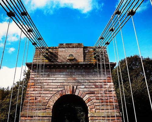 Union Bridge, the world's oldest chain suspension bridge, crosses the River Tweed, UK / Shutterstock / DMC Photogallery