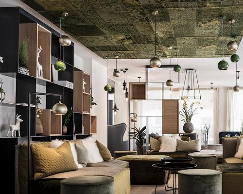 The interior design revolves around furniture and sofas in blue, green and brown tones 'that suggest alpine meadows, biotopes, moss forests or rock caves' / noa*