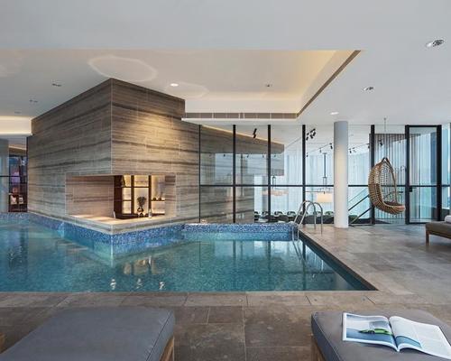 A kitchen, library and bar sit together with a gym, swimming pool and art gallery in the clubhouse / Concrete