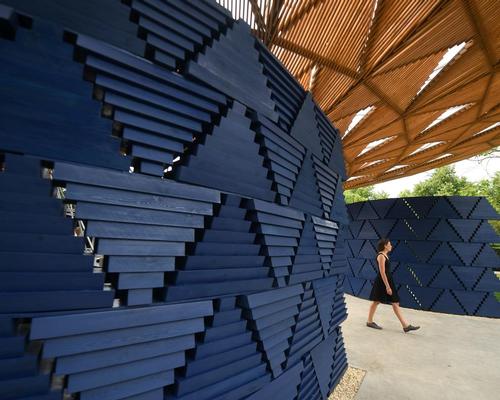 The structure’s bright indigo walls – formed of inverted wooden triangles – are angled so as to let daylight flood in
/ Victoria Jones/PA Images