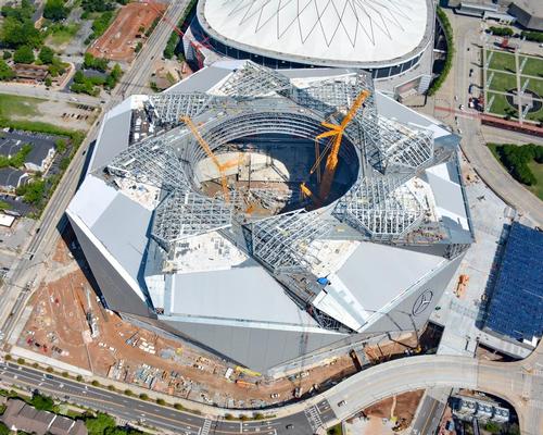 Construction workers are adding the finishing touches to the structure’s unique eight-petal plastic polymer retractable roof / Atlanta Falcons