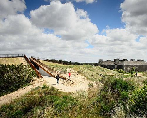 Beyond the bunker, the new museum emerges as a series of intersecting, precise cuts in the shoreland landscape / Mike Bink