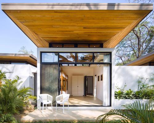 Overlapping timber roofs, made of recycled Teak planks, project out over each pavilion providing shade and creating uneven patterns / Studio Saxe