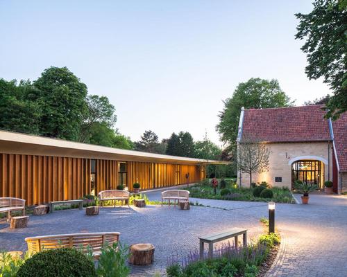 An intimate 'village square' has also been created between the pavilion and the manor farm that forms an outdoor extension of the foyer / Mecanoo architecten