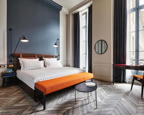 The historical grandeur is echoed in the bedrooms through cornicing, panelling and reclaimed oak chevron timber flooring / The Hoxton, Paris