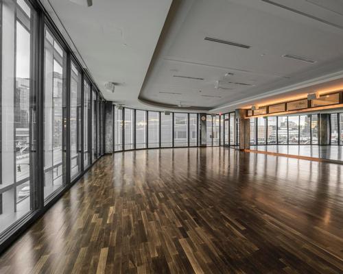 The 35,000sq ft (3,252sq m) club sits on Boston Harbour and has been designed with black granite, exposed steel, black oak and polished wooden floors / Ian Travis Barnard