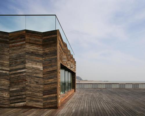 The architects have used timber throughout the project, much of it reclaimed from the original pier: the visitors centre makes a feature of its scorched wood cladding. / Alex de Rijke