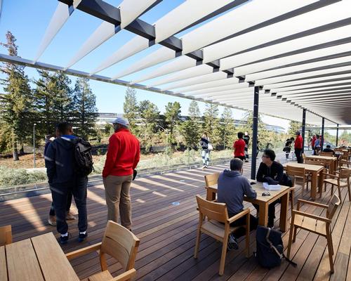 A cafe with outdoor seating lets visitors relax amidst the verdant scenery of the park / Apple