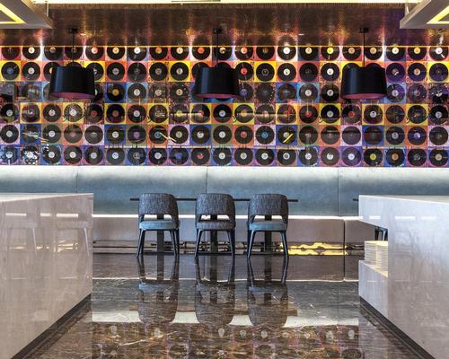 A wall of vinyls features in the main restaurant, Sessions / Nirut Benjabanpot