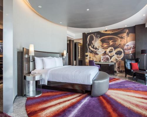 Guest rooms are designed with rotational beds, round psychedelic carpets and custom designed mid-century vintage furnishings / Nirut Benjabanpot
