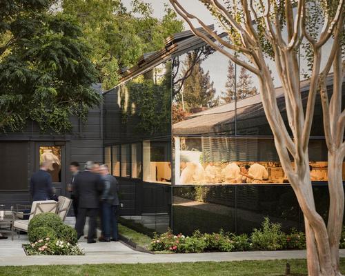  Visitors follow a bluestone path through the entry portal into the heart of the restaurant's garden / Michael Grimm
