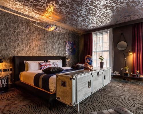 In a nod to the area's industrial heritage, walls are textured like graphite and raw concrete and floors are laid with a special 3D carpet evoking burnt rubber on asphalt / Blue Sky Hospitality