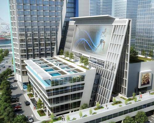 The glass-clad form of the two structures is designed to generate visibility and openness and a functional unity expressing grandeur and prosperity' / John Portman & Associates
