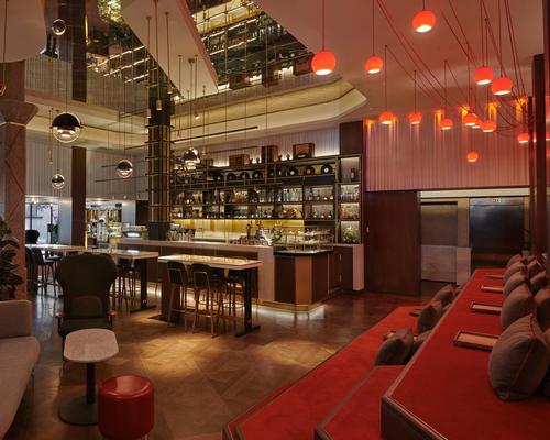 The hotel’s bar is formed of three individual ‘radio pods’ of brass and walnut with a giant antenna stretching across the ceiling / Blue Sky Hospitality