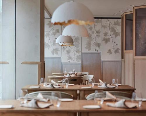  Decorative pendants hang above the tables, which cast a softly-focused warm white glow / Joakim Blockstrom