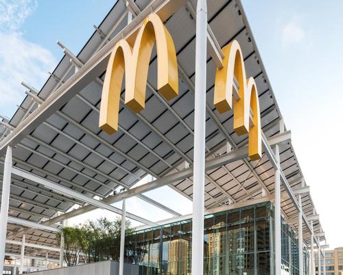 The glass restaurant is covered by a canopy of solar panels / McDonald's