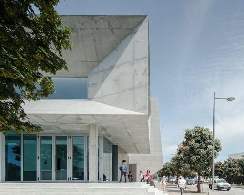 The complex has a brutalist-style facade and consists of various sharp and pointed edges
