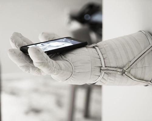 A space glove attached to the wall where guests can place their phones or key cards
/ Michael Najjar 