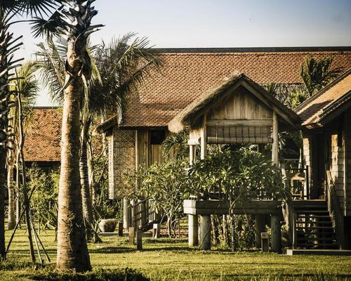 Phum Baitang is formed of 45 spacious, stilted wooden villas traditionally built on eight acres of lush gardens and paddy fields / Asia Hotel Design Awards