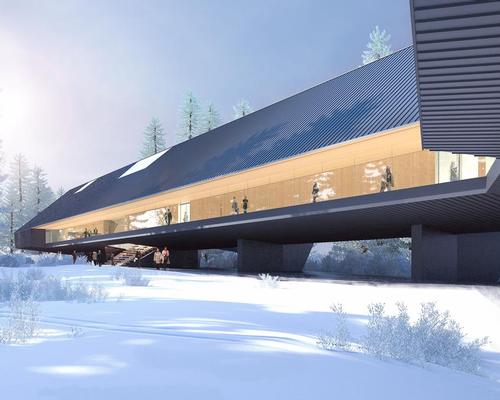 Nestled in the wooded area, the angular museum, clad in dark metal, is raised several metres above the ground due to a flood plain