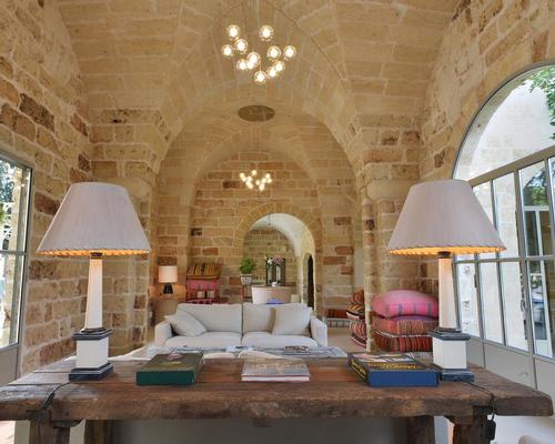 The hotel's interiors feature vaulted ceilings, murals and fireplaces carved in in local Tufo and Piertra Leccese stone / Masseria Trapana 