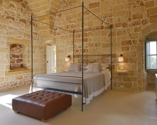 The hotel’s interiors are a combination of original features from the farm, such as cattle feeding troughs found during the renovation, with more modern furnishings / Masseria Trapana 