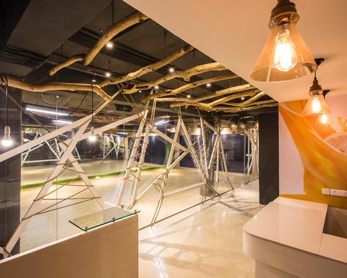 To create a 'contemporary, yet rugged' look, treated wooden branches have been suspended from the ceilings / Studio Ardete