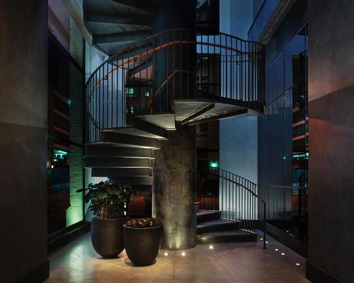 A custom-made steel cylindrical staircase links to the second floor / Design Hotels