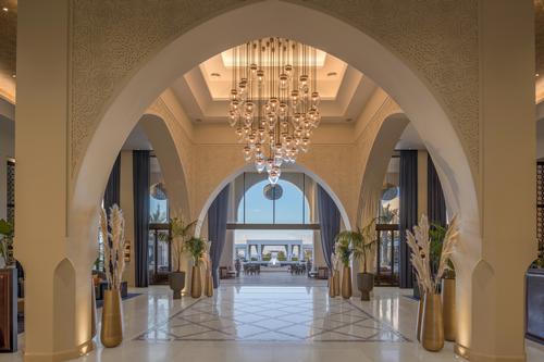 The complex draws on traditional Moroccan and Islamic architecture; horseshow arches and riad-like layouts appear throughout the property. / Courtesy of Hilton Hotels