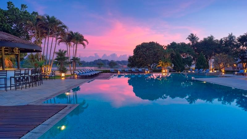 The Perfume River lies beyond the hotel’s salt water swimming pool / 