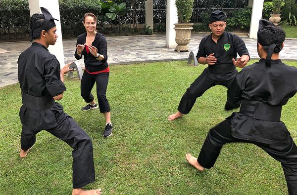 Nicol (second right) takes part in silat melayu, a martial art used to focus delegate’s minds each morning