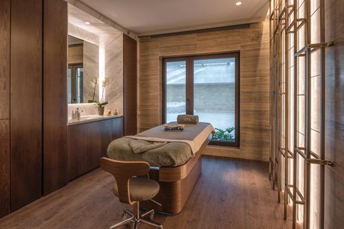 Windows welcome an abundance of natural light into the rooms, which are filled with soft, sandy tones, blue and teal colour accents