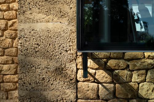 The gym was built using stone from the site that was crushed and 'rammed' into the facing material / James Stephenson