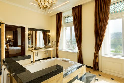 Rooms are furnished with antique furniture and ornate chandeliers / Filipe Wiens