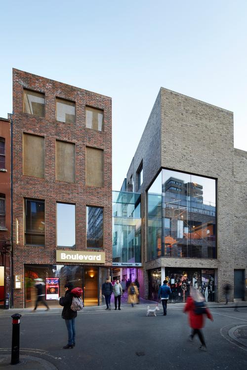 Façades of interlocking bricks clad the theatre buildings / SODA Studio