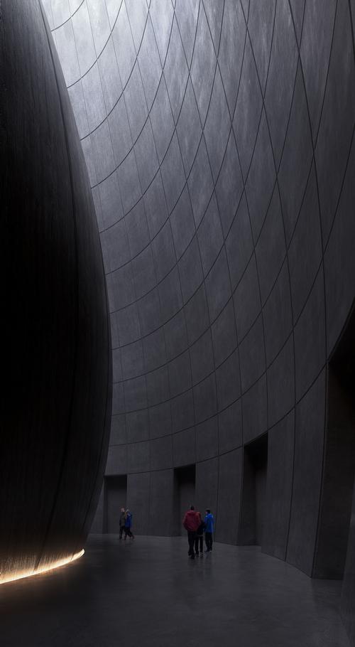 The building is circular and tapers as it rises / Snøhetta