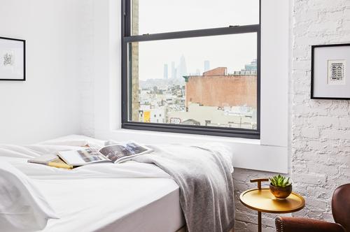 Room details include herringbone wood floors and crisp linens / Read McKendree