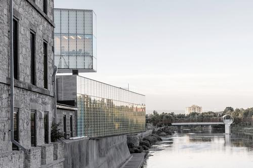 New glass volumes that are cantilevered over the adjacent Grand River / Sanjay Chauhan