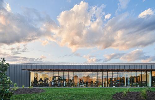Full-height glazing along one side of the building fills the exercise spaces with natural light / Hufft