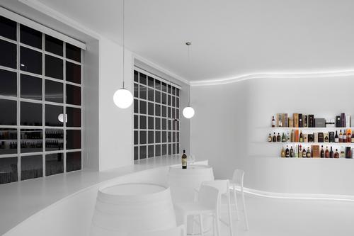 the tasting area is situated to provide views out through the windows of the space / Ivo Tavares Studio