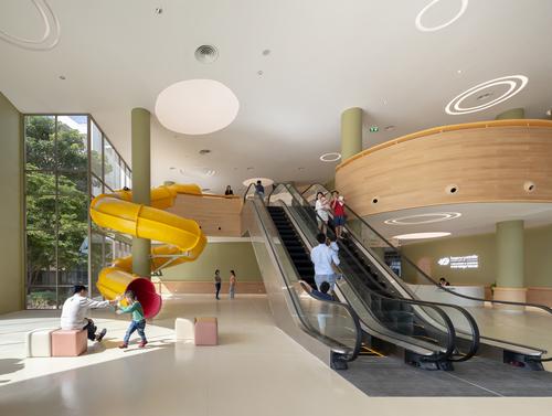 There is a giant slide at the front of the building in the entrance hall / Ketsiree Wongwan