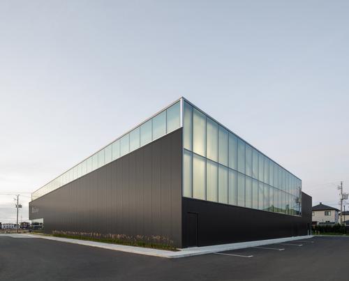 The translucent upper portion and solid black base reference the surrounding agricultural lands and the sky / David Boyer