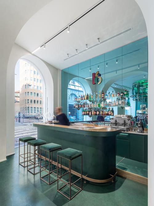 There is a wall of turquoise mirrors behind the bar / Alessandro Saletta for DSL Studio