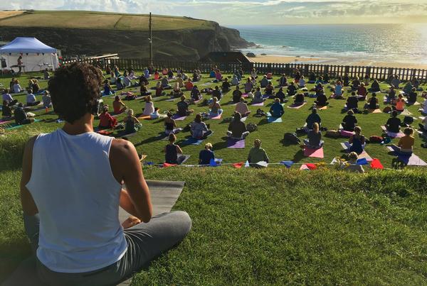 Oceanflow Yoga participants enjoying a meditation class at Bedruthan Steps 
on the Cornish coast