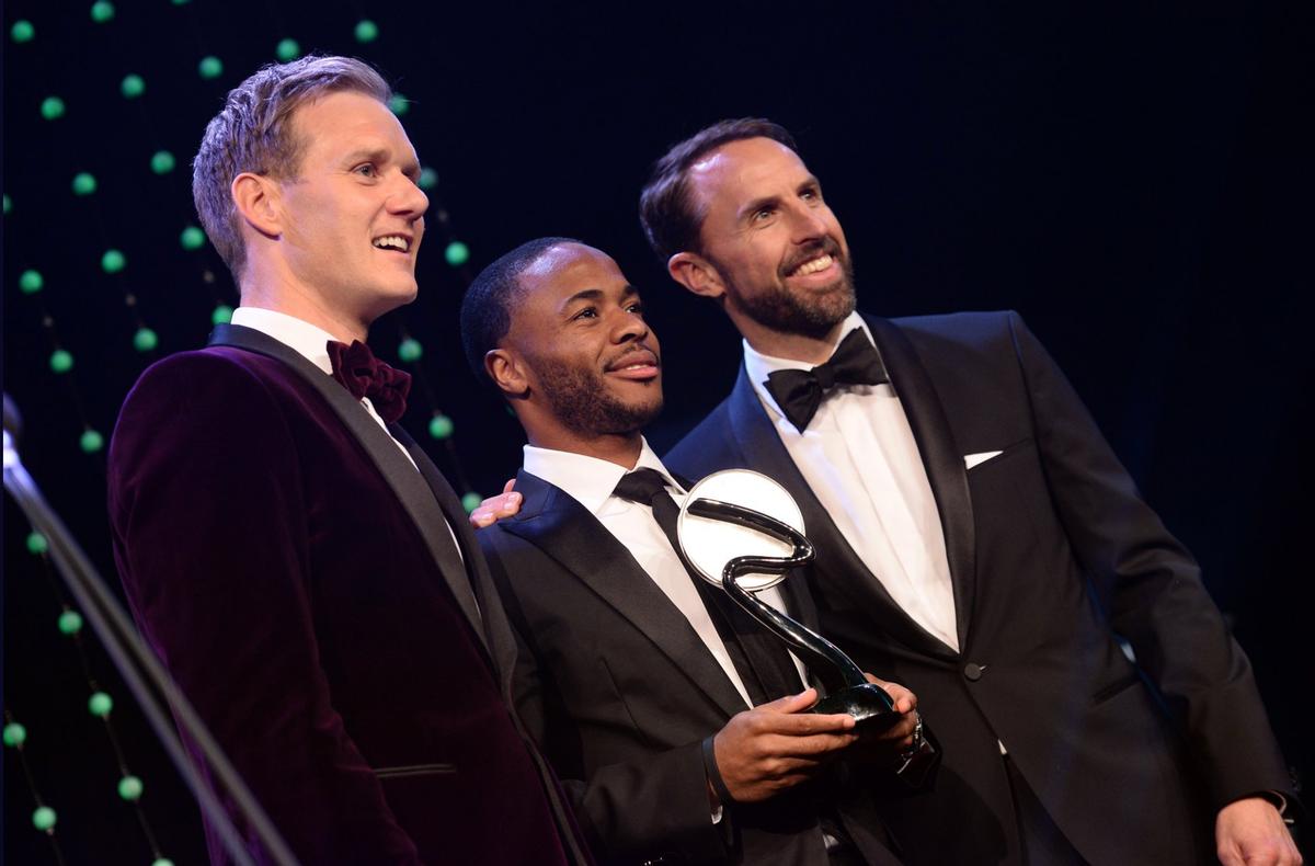 Raheem Sterling (centre) received his Integrity and Impact Award from BBC presenter Dan Walker (left) and England manager Gareth Southgate / Sport Industry Group/ BT Sport Industry Awards Raheem Sterling (centre) received his Integrity and Impact Award from BBC presenter Dan Walker (left) and England manager Gareth Southgate / Sport Industry Group/ BT Sport Industry Awards