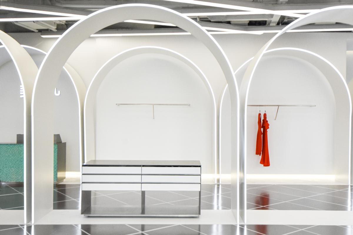 The shop and the café are joined by an runway that is flanked by arched display units / Marcella Campa